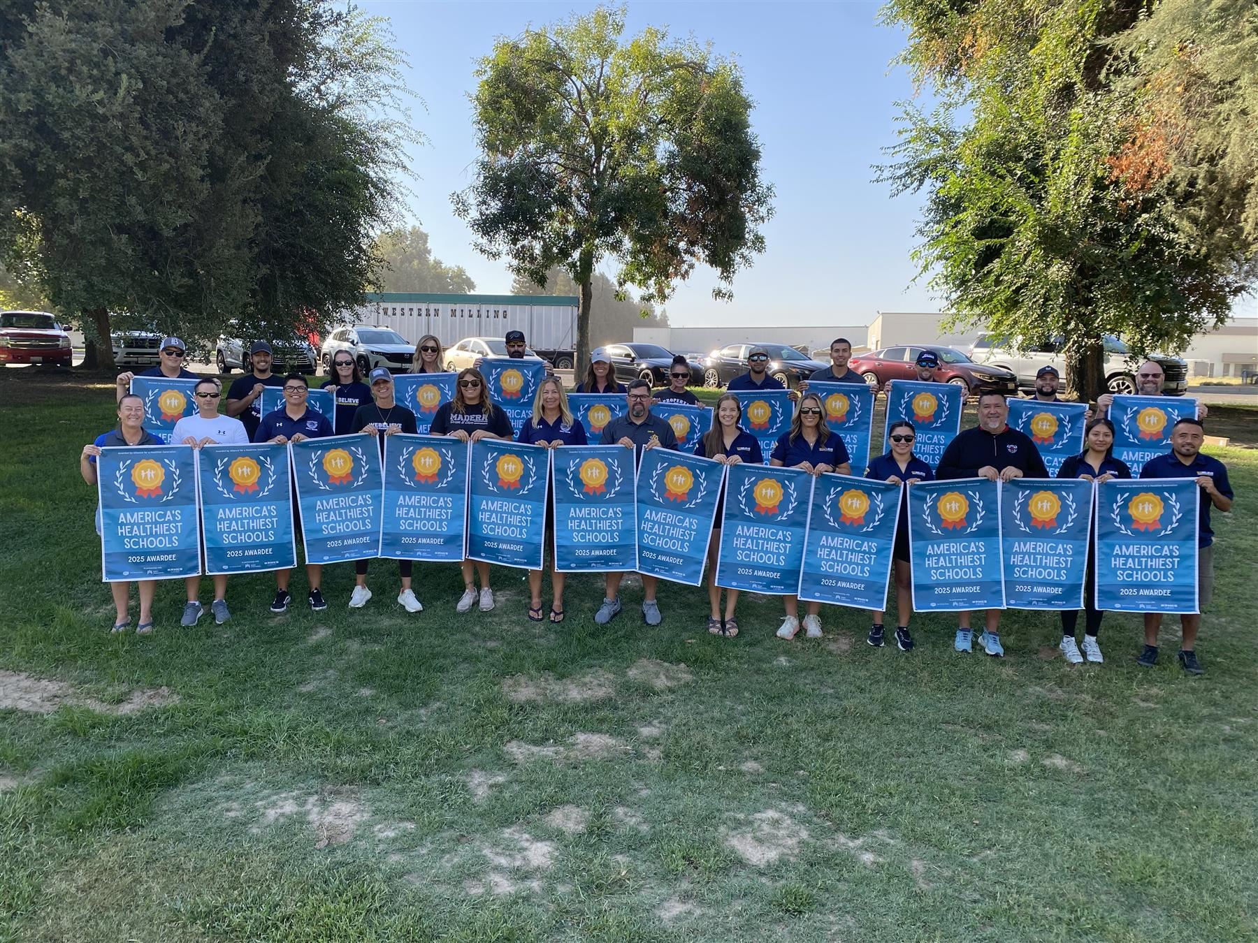 Elementary PE Teachers with Award Banners